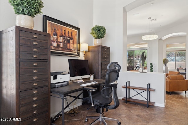 tiled office with arched walkways and baseboards
