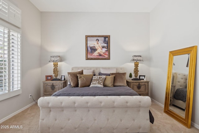 bedroom featuring light colored carpet, multiple windows, and baseboards