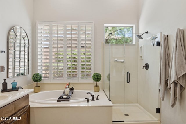 bathroom with a shower stall, a garden tub, and vanity