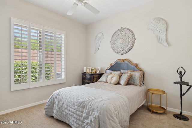 carpeted bedroom featuring baseboards and ceiling fan