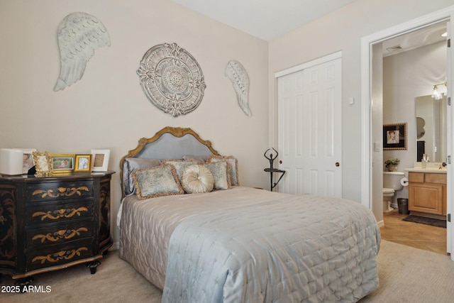 bedroom featuring a closet and ensuite bath