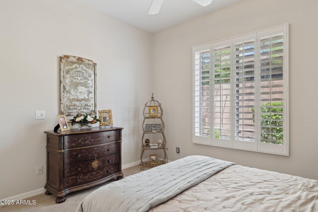 carpeted bedroom with baseboards and ceiling fan