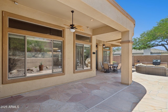 view of patio / terrace with a ceiling fan, fence, outdoor lounge area, and outdoor dining area