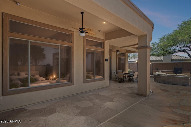 view of patio / terrace with ceiling fan, fence, and outdoor dining area