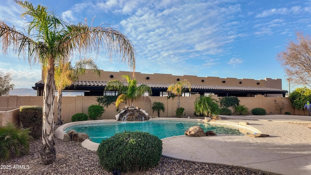 view of swimming pool featuring a fenced backyard, a fenced in pool, and a patio