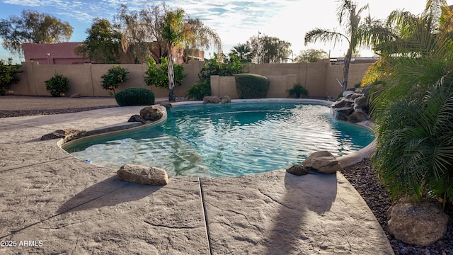 view of swimming pool with a fenced in pool and a fenced backyard