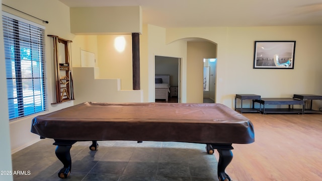 playroom featuring arched walkways, pool table, and baseboards