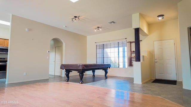 game room with arched walkways, billiards, visible vents, vaulted ceiling, and track lighting