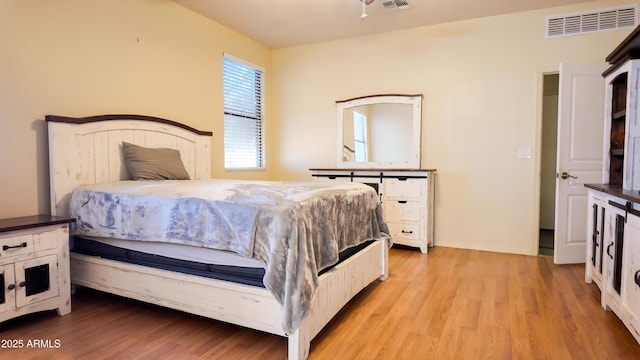 bedroom featuring visible vents and light wood-style flooring