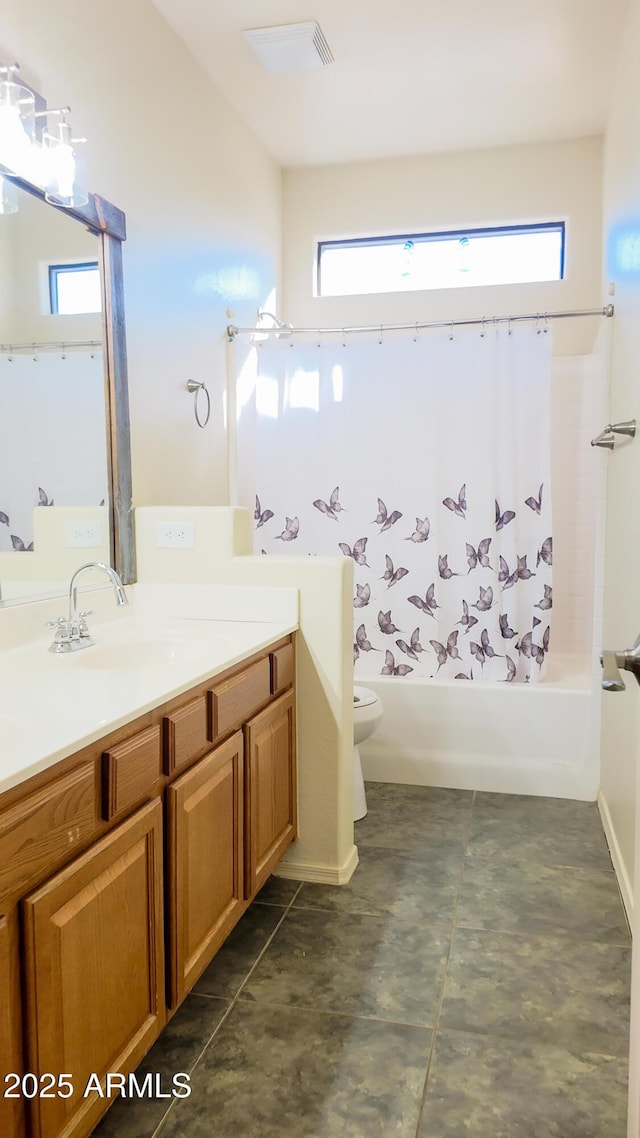 bathroom featuring shower / bath combination with curtain, a healthy amount of sunlight, vanity, and toilet