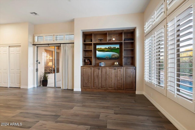 unfurnished living room featuring dark wood-type flooring