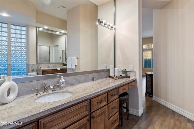 bathroom featuring backsplash, hardwood / wood-style floors, and vanity