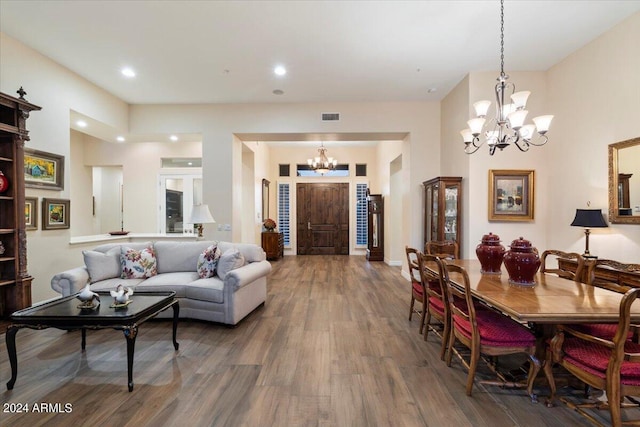 living room with hardwood / wood-style floors and an inviting chandelier