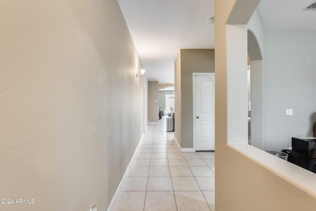 hall with light tile patterned floors