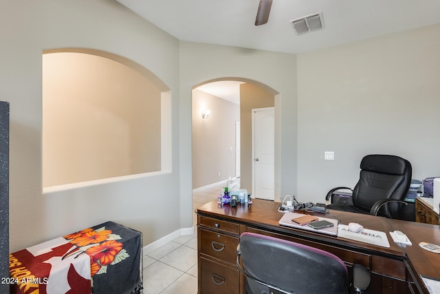 tiled home office featuring ceiling fan