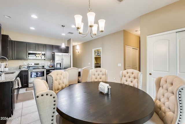 tiled dining space featuring an inviting chandelier and sink