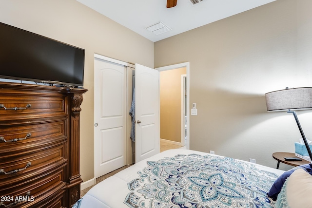 bedroom featuring ceiling fan and a closet