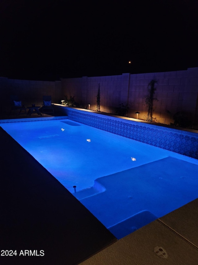 view of pool at night