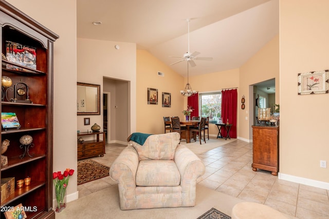 tiled living room with lofted ceiling and ceiling fan with notable chandelier