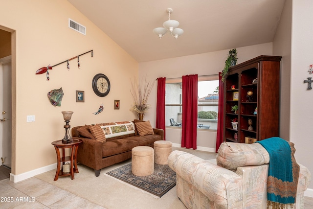 living room with tile patterned floors and a chandelier