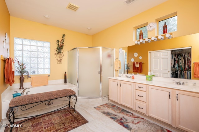 bathroom featuring vanity and independent shower and bath