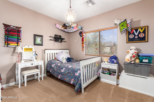 bedroom with carpet and an inviting chandelier