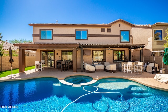 view of swimming pool with a patio area, an in ground hot tub, and exterior bar