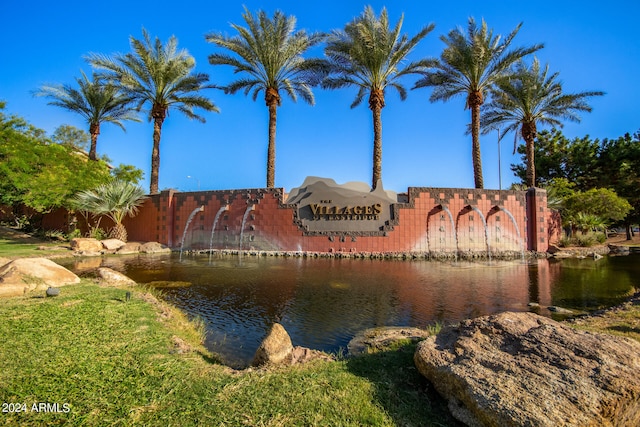 community / neighborhood sign featuring a water view