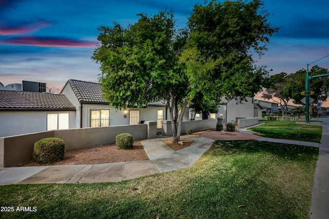 view of front of property with a lawn