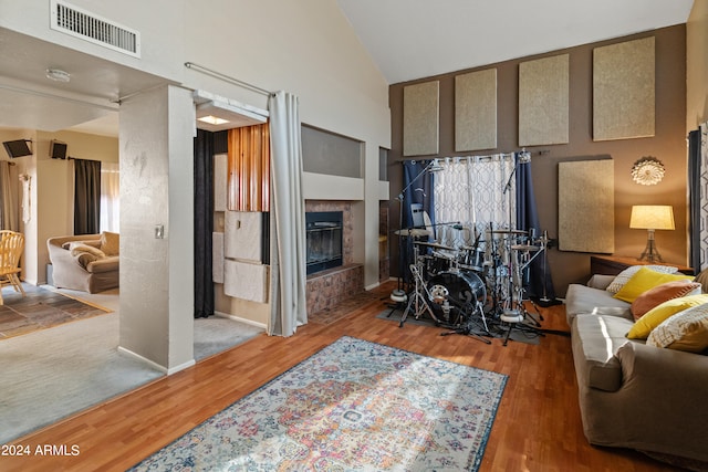 living room featuring vaulted ceiling and hardwood / wood-style floors