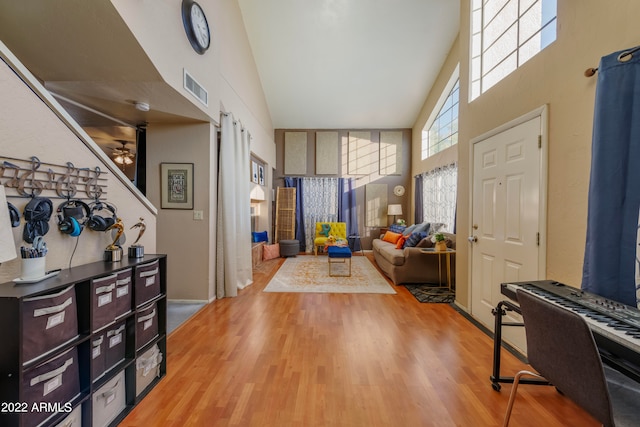 entrance foyer featuring hardwood / wood-style floors and high vaulted ceiling