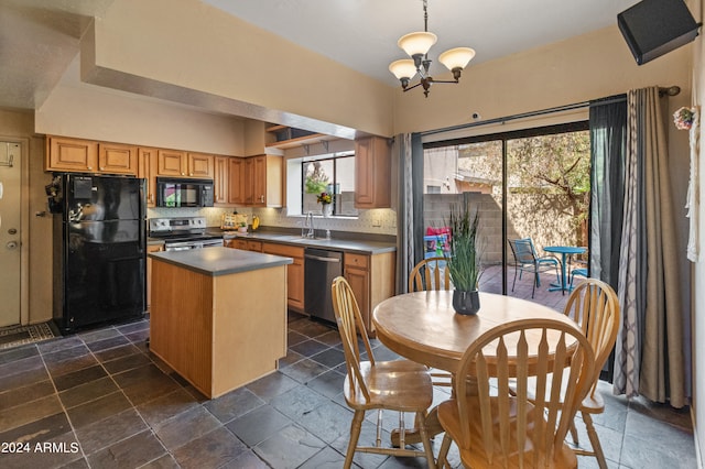 kitchen with a center island, tasteful backsplash, sink, black appliances, and decorative light fixtures