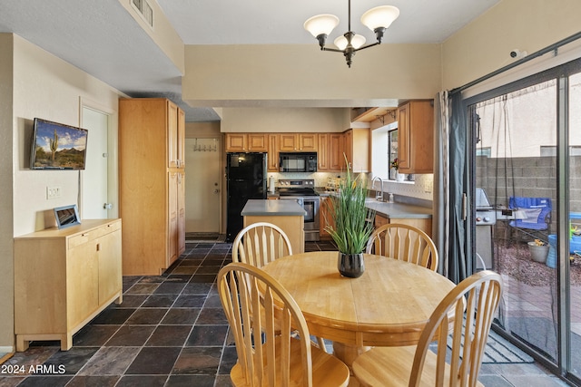 dining area featuring a notable chandelier and sink