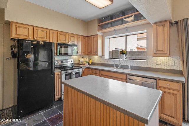 kitchen featuring backsplash, black appliances, a center island, and sink