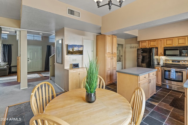 kitchen with a kitchen island, black appliances, light brown cabinetry, a notable chandelier, and decorative backsplash