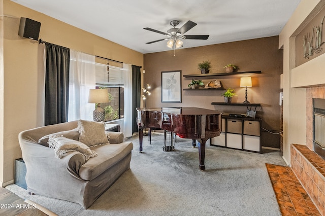 carpeted home office featuring ceiling fan and a tile fireplace