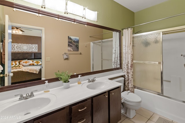 full bathroom with ceiling fan, vanity, toilet, shower / tub combo, and tile patterned flooring