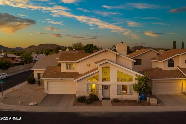 view of front of house with a garage and a mountain view