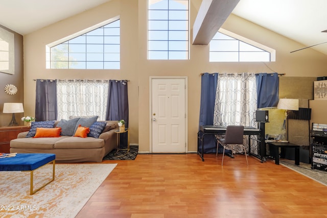 living room with high vaulted ceiling and wood-type flooring