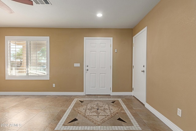 tiled entrance foyer with ceiling fan