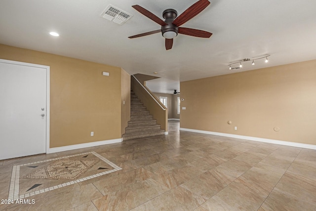 unfurnished living room with ceiling fan