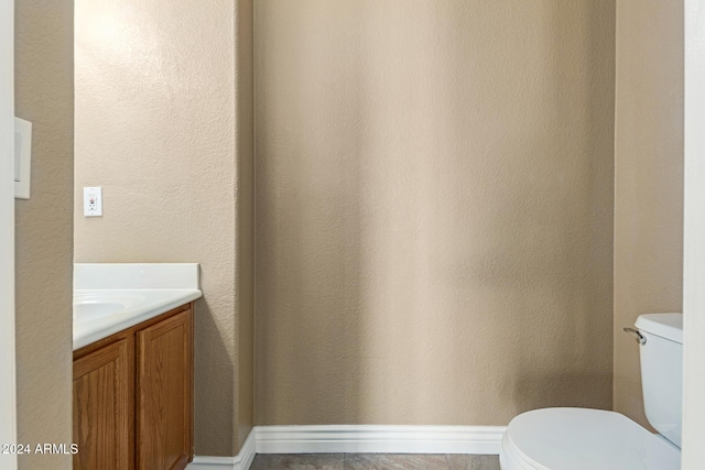 bathroom featuring tile patterned floors, vanity, and toilet