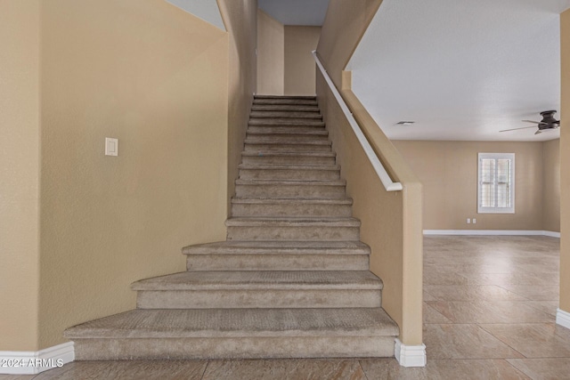 stairs with ceiling fan