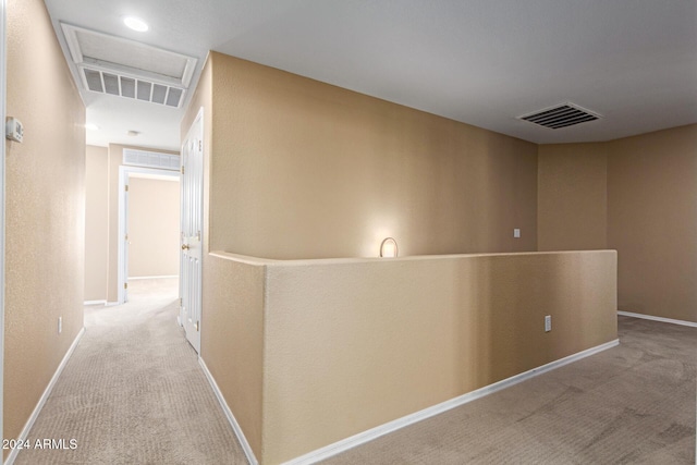 corridor with light colored carpet