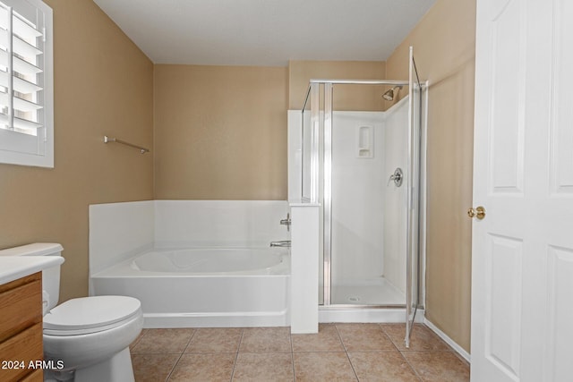 full bathroom featuring tile patterned floors, vanity, toilet, and shower with separate bathtub