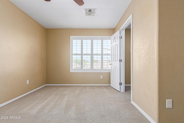 unfurnished bedroom featuring ceiling fan and light carpet