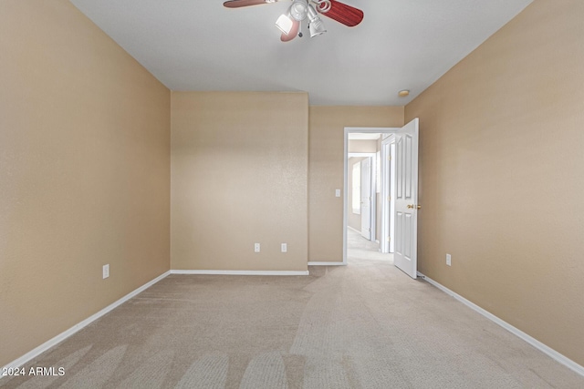 empty room with light carpet and ceiling fan