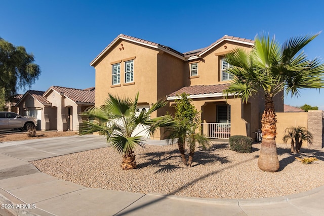 mediterranean / spanish-style home with covered porch