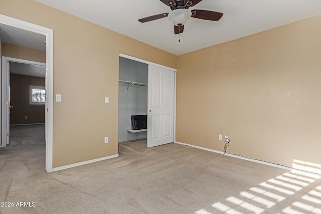 unfurnished bedroom with ceiling fan, a closet, and carpet floors