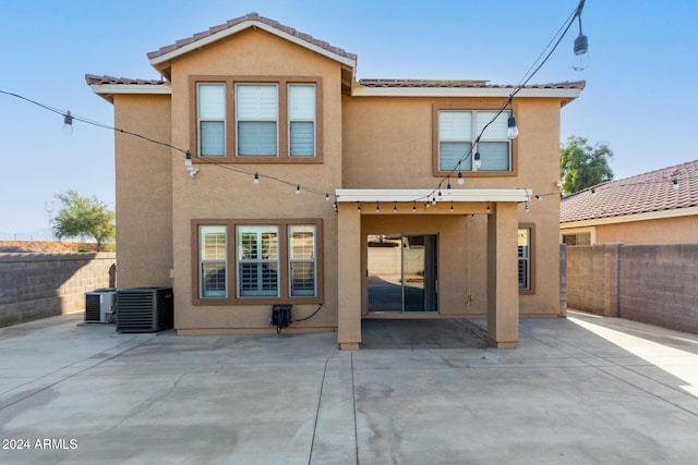 rear view of property featuring a patio area and central air condition unit